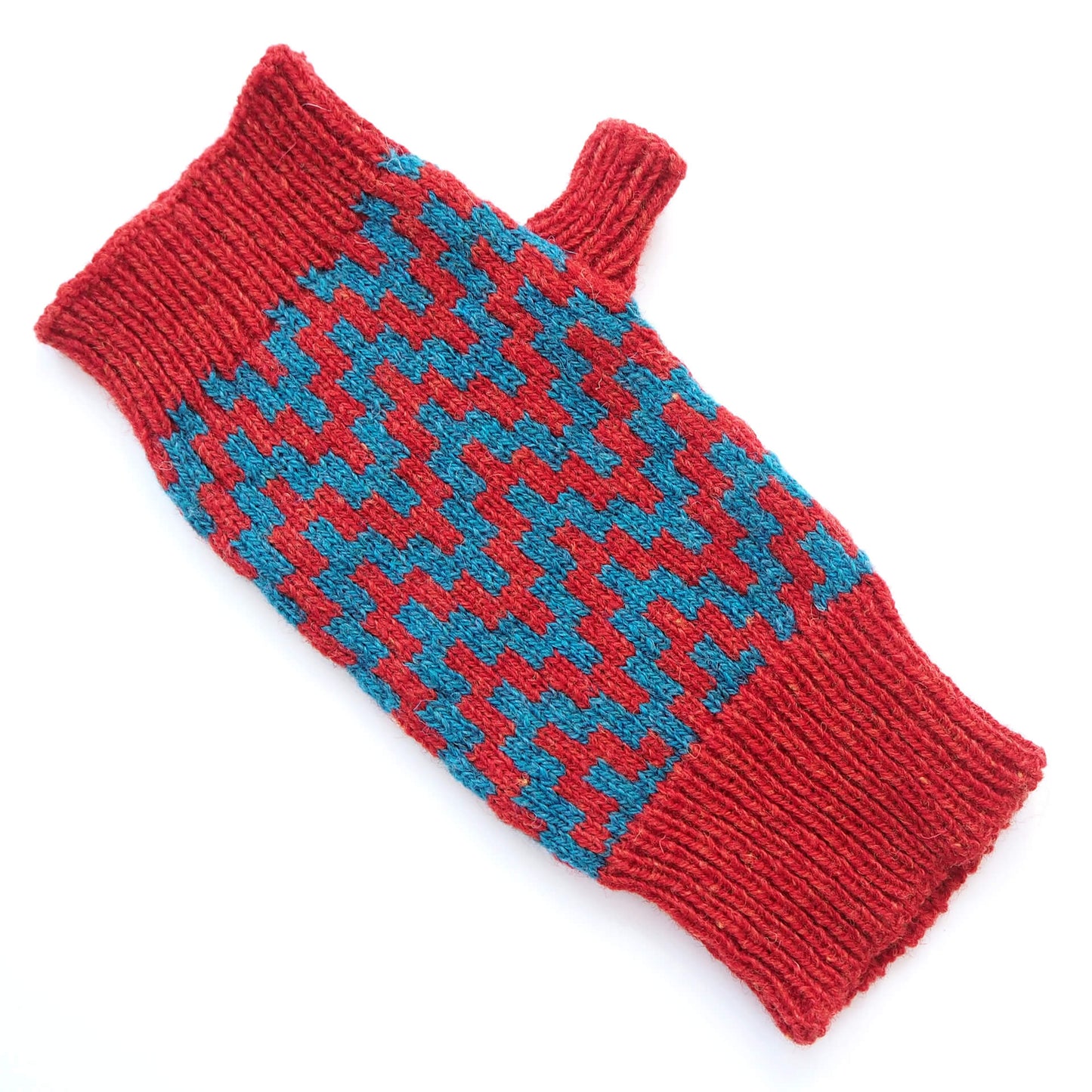 A fingerless glove by K.Moods, it is red with a thick blue zig-zag pattern, and sits on a white background. 
